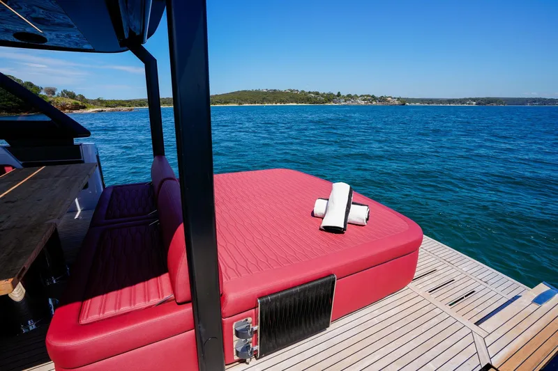  Yacht Photos Pics 2025 Cranchi A46 Luxury Tender with red sunbed on deck, ocean view.