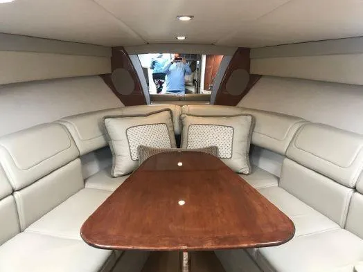  Yacht Photos Pics 2017 Formula 350 Sun Sport cabin with beige seating and wooden table.