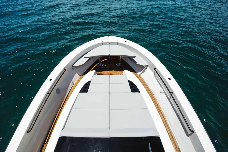 Bluegame 62 Yacht Photos Pics 2019 Bluegame BG62 yacht bow with sunbathing area on open water.