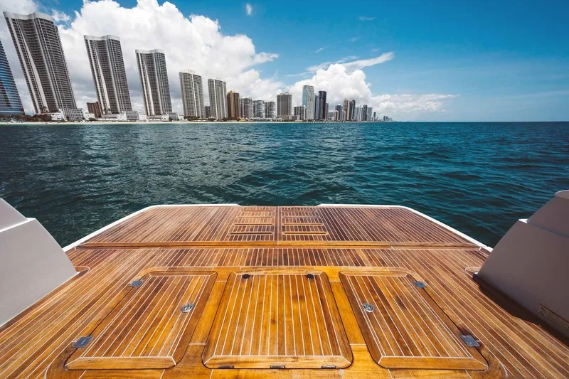 Bluegame 62 Yacht Photos Pics View from the deck of a 2019 Bluegame BG62 yacht overlooking a coastal city skyline.