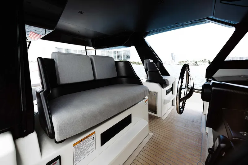Bluegame 62 Yacht Photos Pics Interior helm station of 2019 Bluegame BG62 yacht with modern seating and steering wheel.