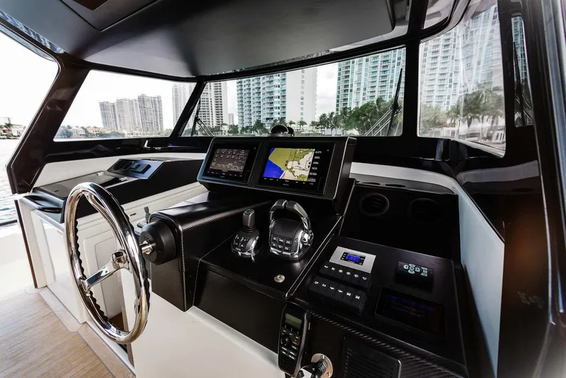 Bluegame 62 Yacht Photos Pics 2019 Bluegame BG62 yacht helm with modern navigation equipment and cityscape view.