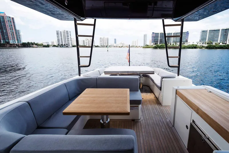 Bluegame 62 Yacht Photos Pics 2019 Bluegame BG62 yacht with spacious outdoor seating and waterfront view.