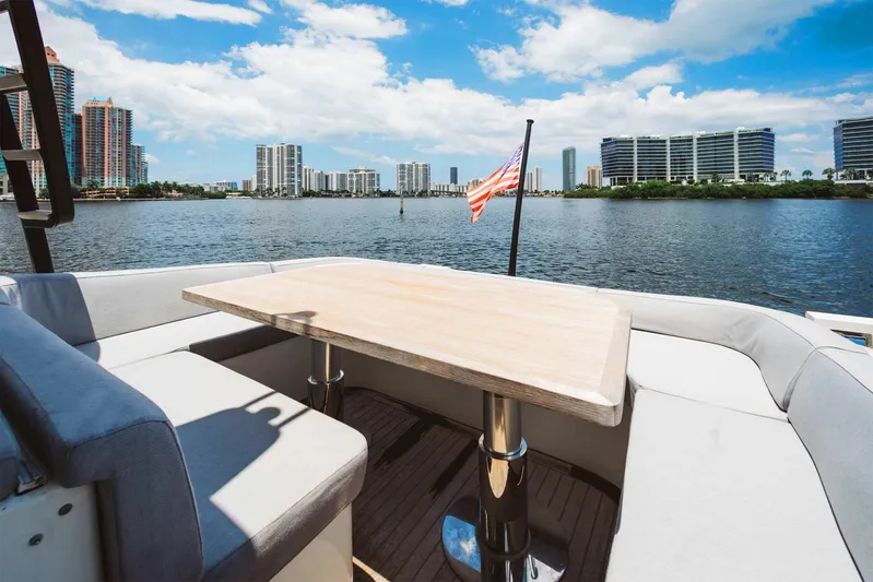 Bluegame 62 Yacht Photos Pics 2019 Bluegame BG62 yacht with waterfront cityscape view and American flag.