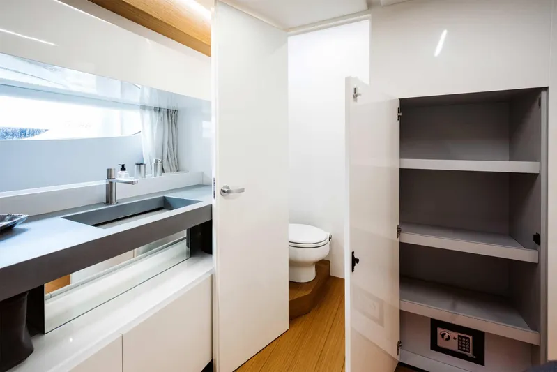 Bluegame 62 Yacht Photos Pics Modern bathroom in 2019 Bluegame BG62 yacht with sink, toilet, and storage cabinet.
