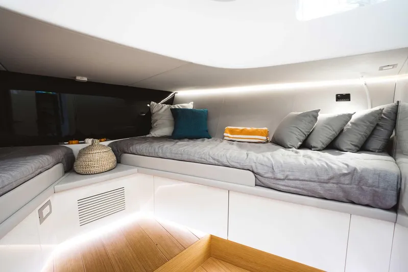 Bluegame 62 Yacht Photos Pics Modern interior cabin of 2019 Bluegame BG62 yacht with cozy bedding and ambient lighting.