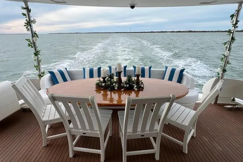  Yacht Photos Pics 2004 Lazzara SC Motor Yacht deck with elegant dining setup and ocean view.