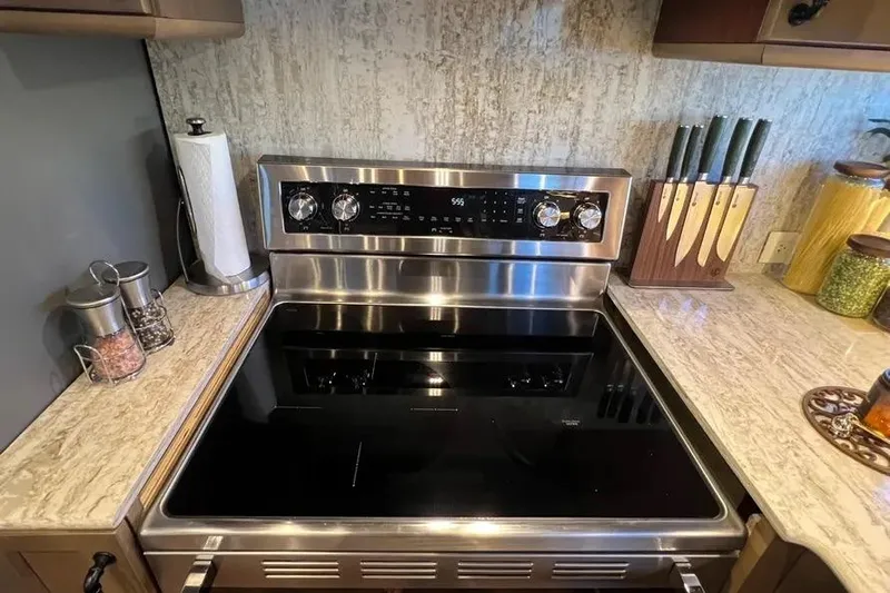  Yacht Photos Pics Modern kitchen stove with stainless steel finish on a 2004 Lazzara SC Motor Yacht.