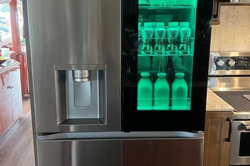  Yacht Photos Pics Stainless steel refrigerator with illuminated glass door on 2004 Lazzara SC Motor Yacht.