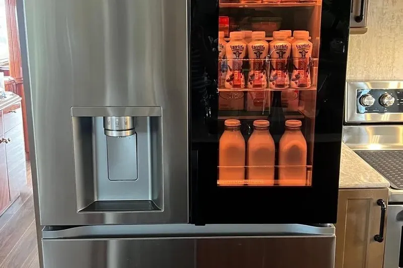  Yacht Photos Pics Stainless steel refrigerator on 2004 Lazzara SC Motor Yacht, stocked with beverages.