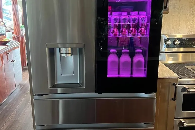  Yacht Photos Pics Modern stainless steel refrigerator with purple-lit beverage display on a 2004 Lazzara SC Motor Yacht.