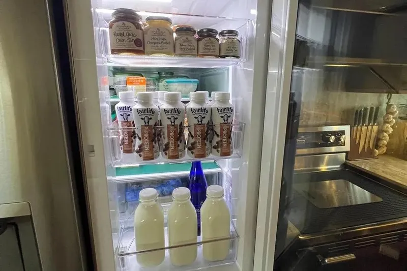  Yacht Photos Pics Refrigerator stocked with protein drinks, milk, and condiments on a 2004 Lazzara SC Motor Yacht.