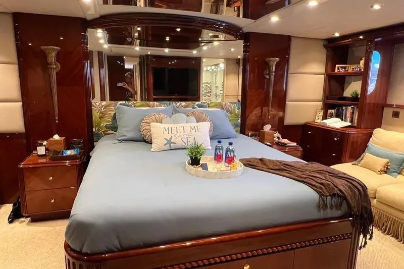  Yacht Photos Pics Luxurious bedroom interior of 2004 Lazzara SC Motor Yacht with elegant decor and cozy bedding.
