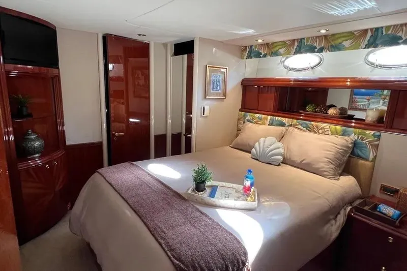  Yacht Photos Pics Luxurious bedroom interior of 2004 Lazzara SC Motor Yacht with elegant decor and cozy bedding.