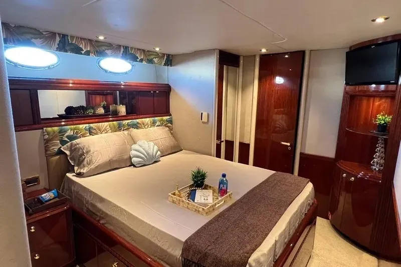  Yacht Photos Pics Luxurious bedroom interior of 2004 Lazzara SC Motor Yacht with elegant decor and amenities.