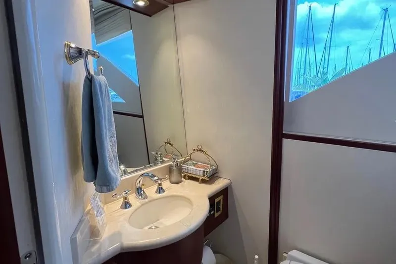  Yacht Photos Pics Luxurious bathroom interior of 2004 Lazzara SC Motor Yacht with elegant fixtures and marina view.