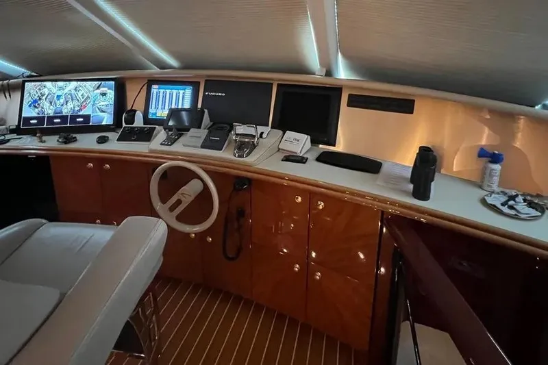  Yacht Photos Pics 2004 Lazzara SC Motor Yacht helm with advanced navigation systems and luxurious wood finish.