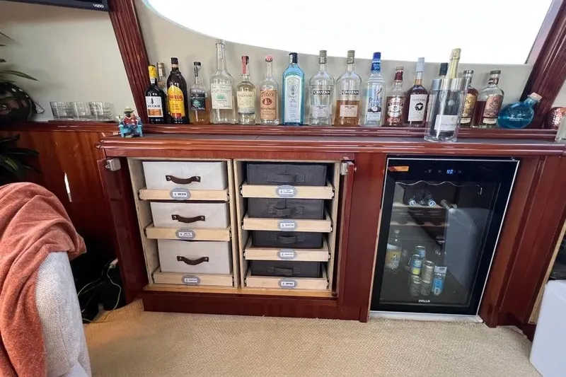  Yacht Photos Pics Luxurious bar setup on a 2004 Lazzara SC Motor Yacht with liquor bottles and mini fridge.