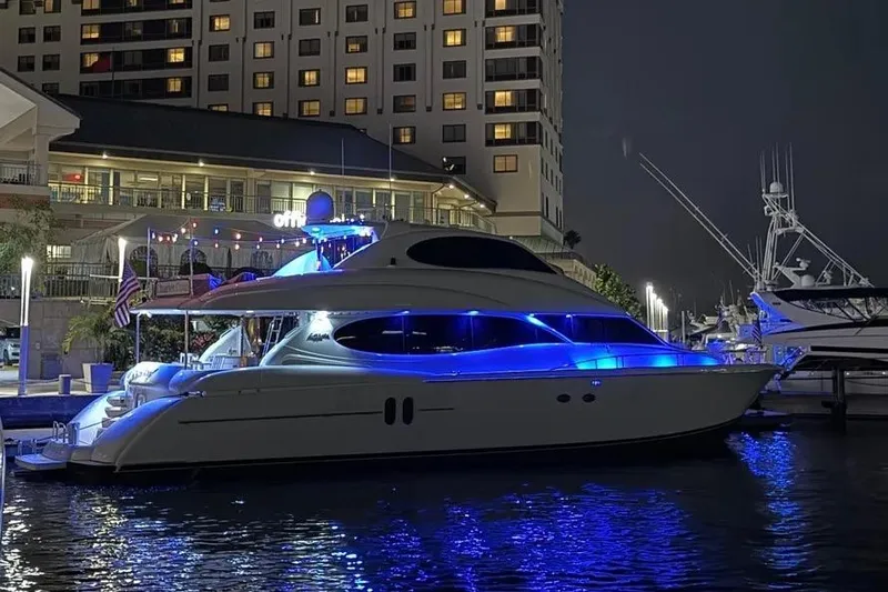  Yacht Photos Pics 2004 Lazzara SC Motor Yacht illuminated at night in marina, with blue accent lighting.