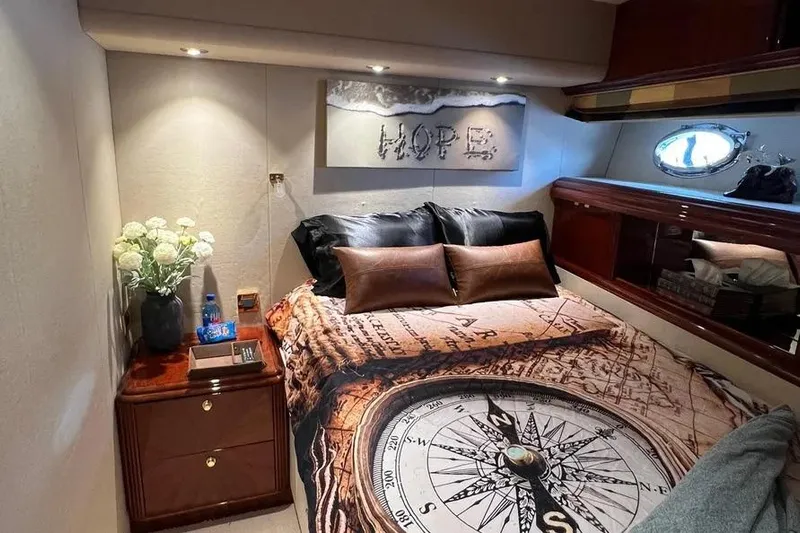  Yacht Photos Pics Luxurious 2004 Lazzara SC Motor Yacht bedroom with compass-themed bedding and elegant decor.