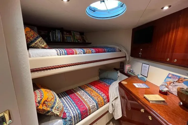  Yacht Photos Pics Luxurious 2004 Lazzara SC Motor Yacht cabin with colorful bunk beds and elegant wood cabinetry.