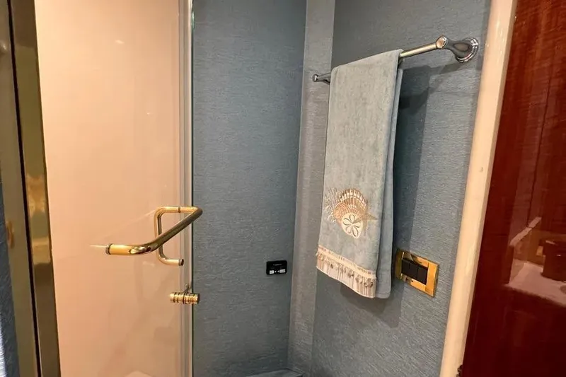  Yacht Photos Pics Luxurious bathroom in 2004 Lazzara SC Motor Yacht with elegant towel and gold accents.