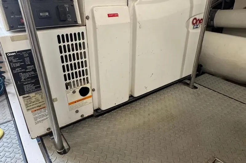  Yacht Photos Pics Onan generator in 2004 Lazzara SC Motor Yacht engine room, featuring metal flooring.