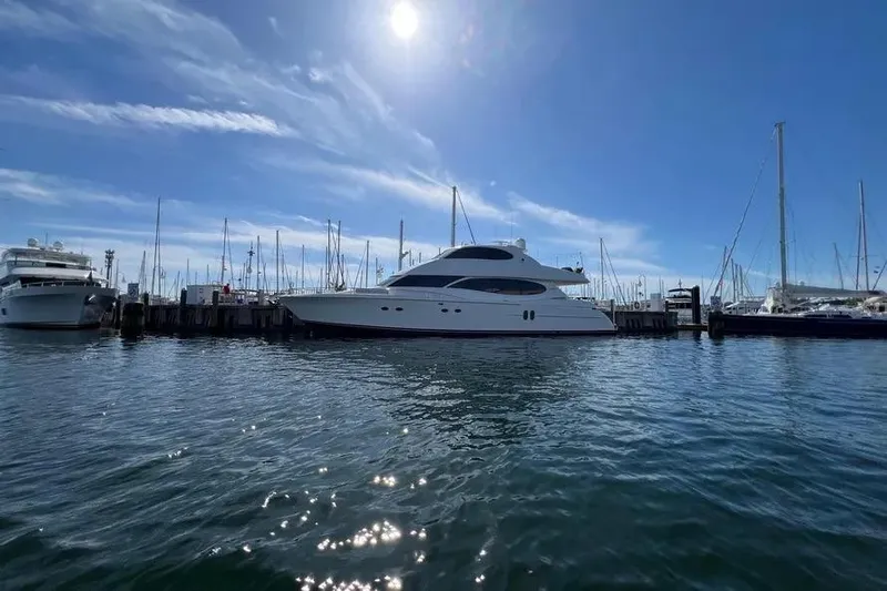  Yacht Photos Pics 2004 Lazzara SC Motor Yacht docked under a sunny sky, surrounded by sailboats.