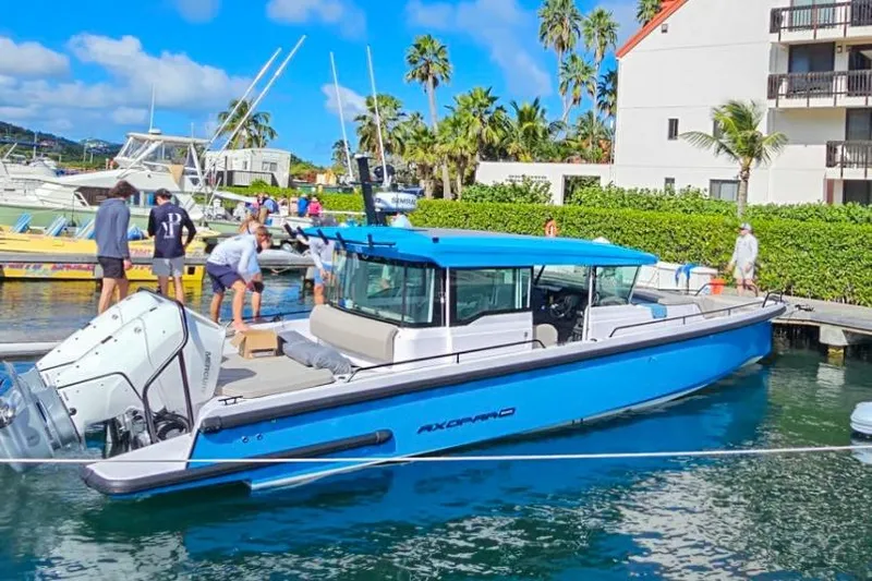  Yacht Photos Pics 2024 Axopar 37XC CROSS CABIN boat docked in a marina with people nearby.