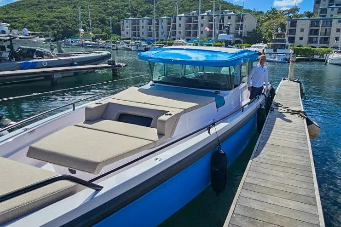  Yacht Photos Pics 2024 Axopar 37XC CROSS CABIN docked at marina, featuring sleek design and spacious deck.