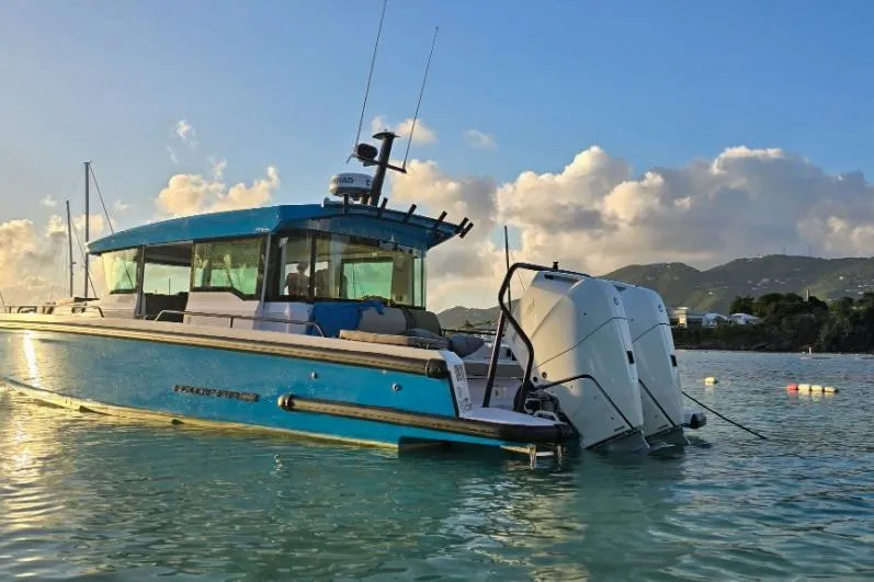  Yacht Photos Pics 2024 Axopar 37XC CROSS CABIN boat on tranquil water at sunset.