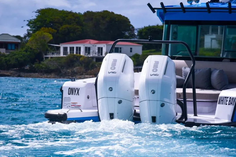  Yacht Photos Pics 2024 Axopar 37XC CROSS CABIN with dual outboard engines on the water.