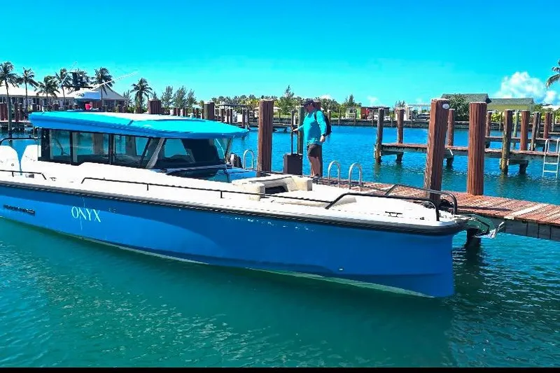  Yacht Photos Pics 2024 Axopar 37XC CROSS CABIN boat docked in a sunny marina setting.