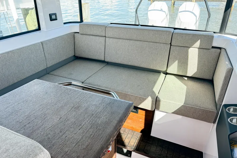  Yacht Photos Pics Luxurious seating area in 2024 Axopar 37XC CROSS CABIN with modern gray upholstery.