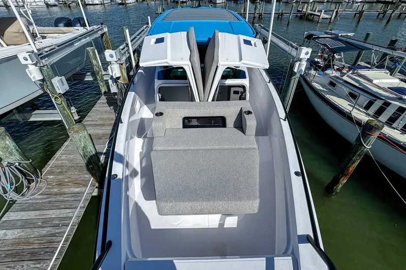 Yacht Photos Pics 2024 Axopar 37XC CROSS CABIN boat docked, featuring open cabin and seating area.