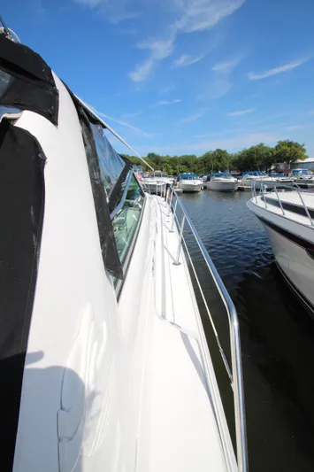  Yacht Photos Pics 1994 Sea Ray 500 Sundancer yacht docked in a marina under clear blue skies.