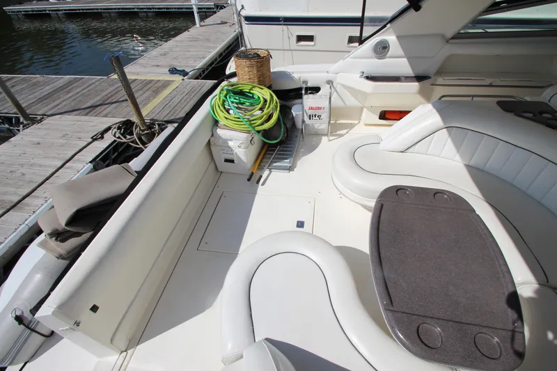  Yacht Photos Pics 1994 Sea Ray 500 Sundancer yacht deck with seating, table, and dock view.