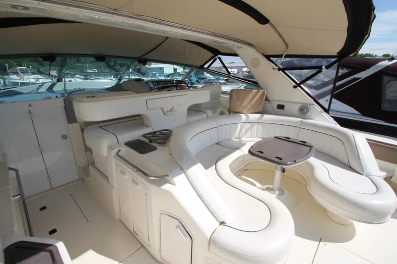  Yacht Photos Pics Luxurious 1994 Sea Ray 500 Sundancer yacht interior with white seating and table.
