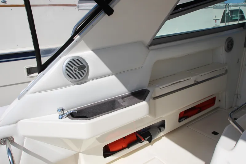  Yacht Photos Pics Interior view of 1994 Sea Ray 500 Sundancer boat, featuring sleek white seating and storage compartments.