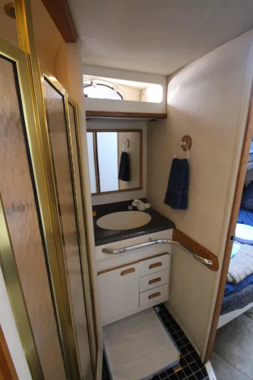  Yacht Photos Pics 1994 Sea Ray 500 Sundancer bathroom with sink, mirror, and shower.