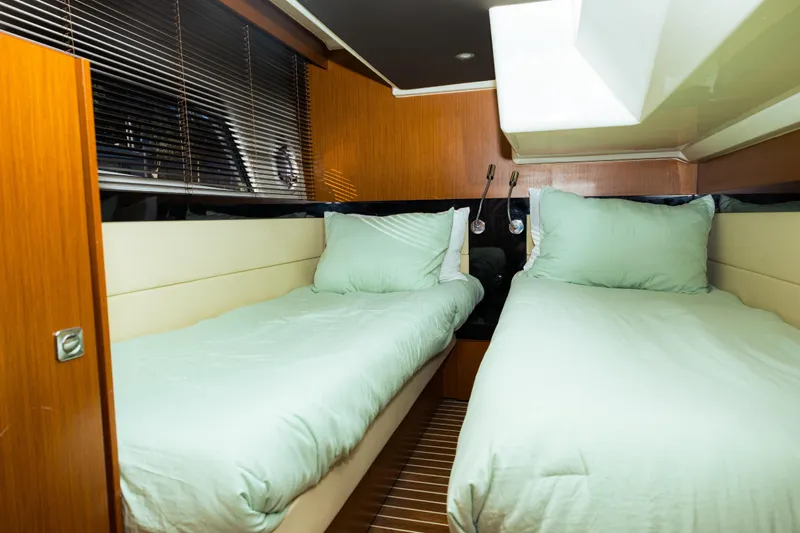  Yacht Photos Pics Interior of 2013 Bavaria Virtess 420 Fly yacht with twin beds and wooden accents.