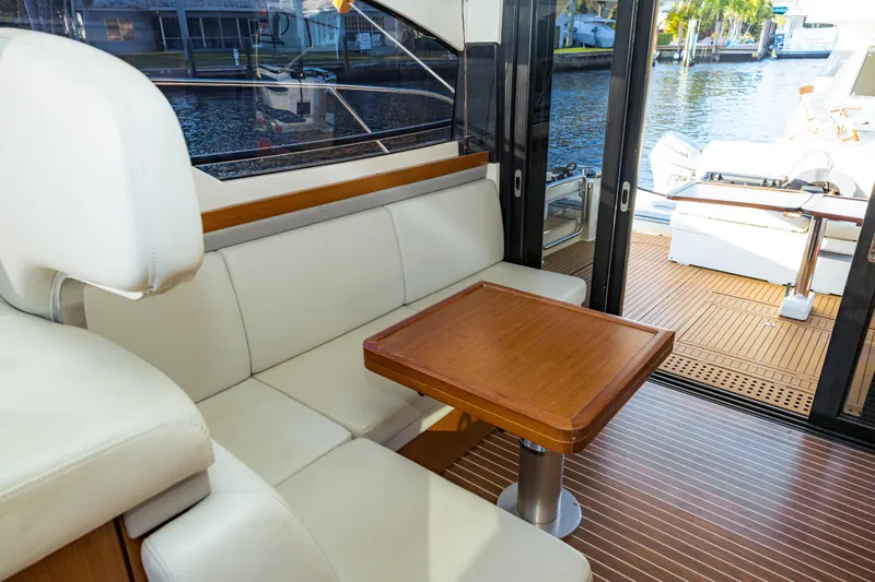  Yacht Photos Pics Luxurious interior of 2013 Bavaria Virtess 420 Fly yacht with elegant seating and wooden table.