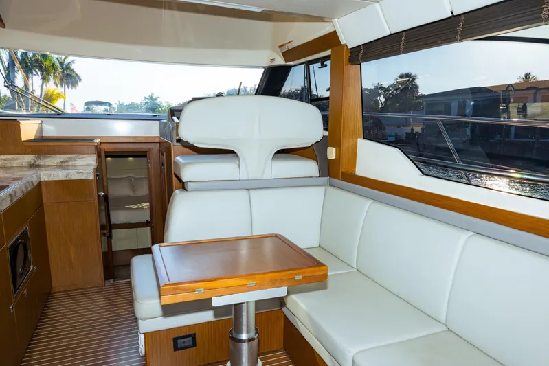  Yacht Photos Pics Interior of 2013 Bavaria Virtess 420 Fly yacht with modern seating and wooden accents.