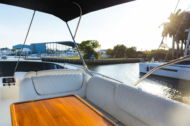  Yacht Photos Pics Luxurious Bavaria Virtess 420 Fly yacht interior, 2013 model, with elegant seating and wooden table.