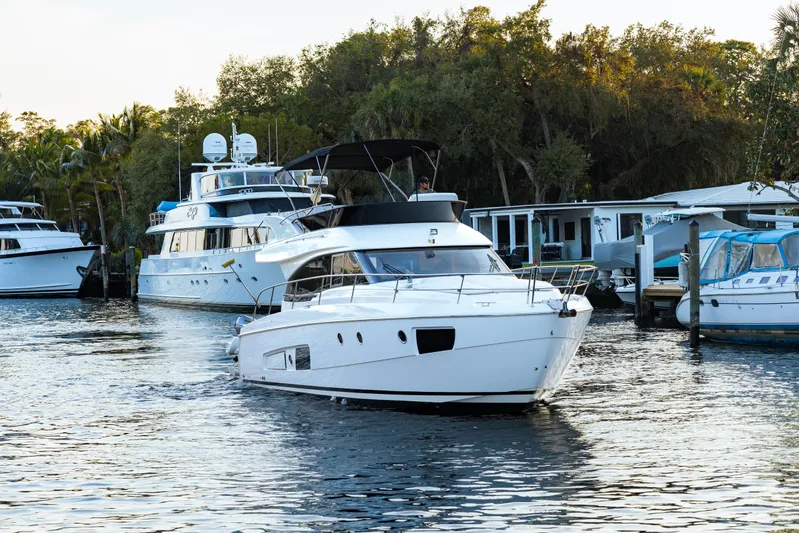  Yacht Photos Pics 2013 Bavaria Virtess 420 Fly yacht cruising in a marina with surrounding boats.