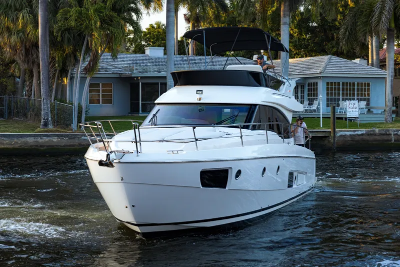  Yacht Photos Pics 2013 Bavaria Virtess 420 Fly yacht cruising near waterfront homes.