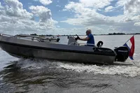 2018 Alufleet Tourer 555 boat cruising on a lake under a cloudy sky.