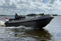 Alufleet Tourer 555 boat cruising on a lake, 2018 model, under cloudy skies.