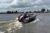 2018 Alufleet Tourer 555 boat cruising on a lake with a Dutch flag.