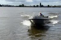 2018 Alufleet Tourer 555 boat cruising on a calm lake under cloudy skies.